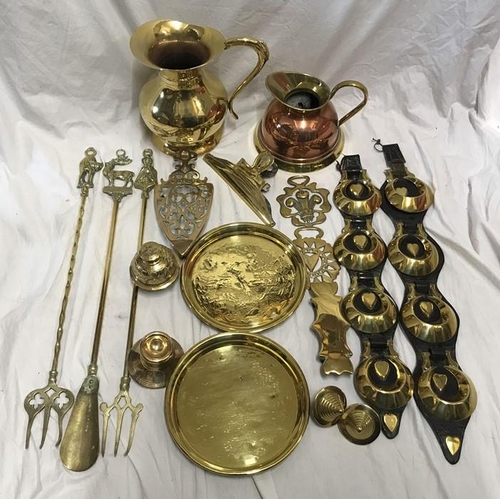 149 - Brassware, Horse brasses on leather strap, toasting forks, trivet, trays, jugs etc.