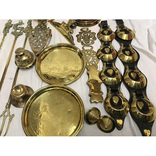 149 - Brassware, Horse brasses on leather strap, toasting forks, trivet, trays, jugs etc.