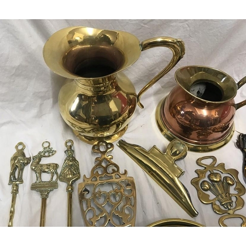 149 - Brassware, Horse brasses on leather strap, toasting forks, trivet, trays, jugs etc.