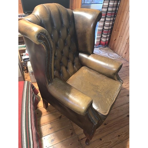 1592 - Two button backed winged leather armchairs. 111h x 88w x 76d cm.