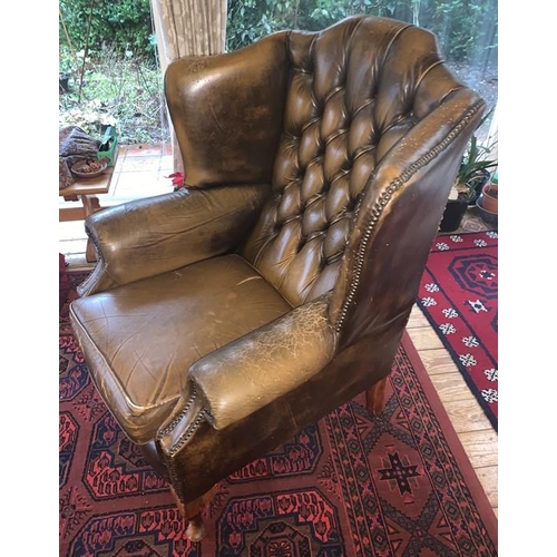 1592 - Two button backed winged leather armchairs. 111h x 88w x 76d cm.