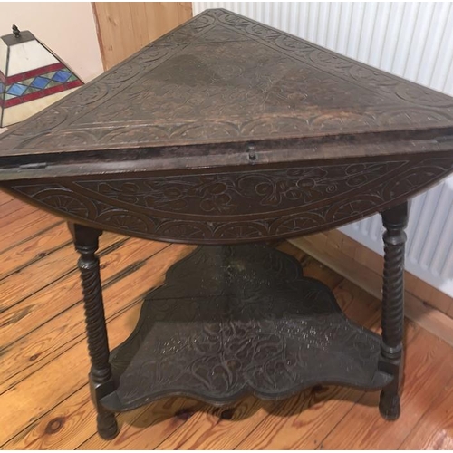 1593 - Carved oak drop leaf occasional table on three turned supports. Triangular in shape opening to a rou... 