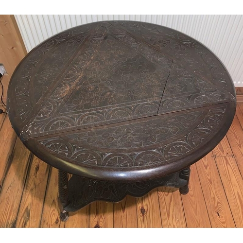 1593 - Carved oak drop leaf occasional table on three turned supports. Triangular in shape opening to a rou... 