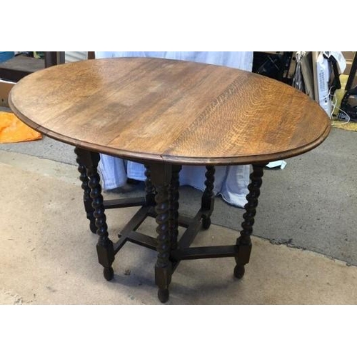 1601 - A barley sugar twist gateleg solid oak drop leaf table In good condition for age.106cm l x 76cm w x ... 