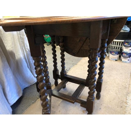 1601 - A barley sugar twist gateleg solid oak drop leaf table In good condition for age.106cm l x 76cm w x ... 