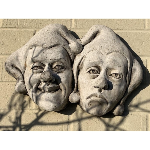 1625 - Wall masks of clowns, reconstituted stone. 41 w x 25cms h.