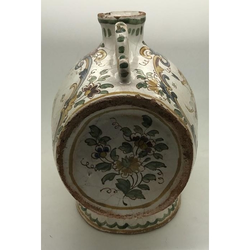 221 - A faience barrel shape spirit flask with polychrome decoration. Marked to the base with script F. 15... 