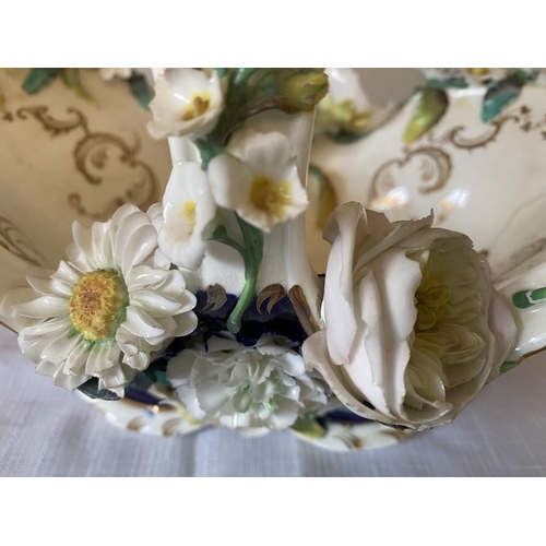 231 - A 19thC floral encrusted basket with a continental planter.