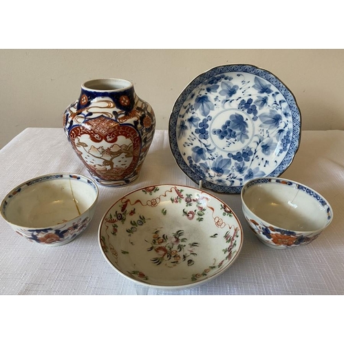 234 - Oriental ceramics to include two 18thC tea bowls, a saucer, a 20thC dish and a 19thC Imari vase 14cm... 