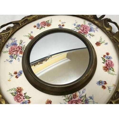 253 - A decorative circular brass mirror with Burleigh Ware rose pattern plate, 31cms d.