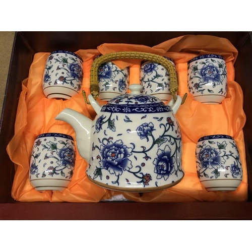 258 - Chinese Wanyang ceramics boxed tea set, teapot and 6 beakers, blue and white floral pattern, wicker ... 