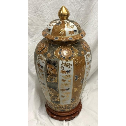 259 - Large Chinese pottery gilt and floral decorated lidded vase on carved wooden stand. 58cms h.