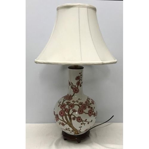 260 - Chinese pottery table lamp on carved wooden base, Cherry Blossom pattern. Lamp 39cms h with shade 67... 