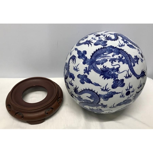 262A - Large Chinese Blue and White Dragon patterned pottery ball on carved wooden stand base 35cms h.