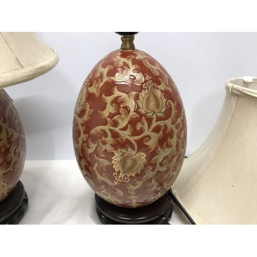 263 - Pair of Chinese pottery gilt and red floral and leaf pattern table lamps, egg shaped oval, on carved... 