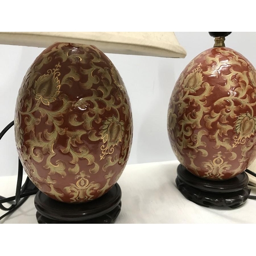 263 - Pair of Chinese pottery gilt and red floral and leaf pattern table lamps, egg shaped oval, on carved... 