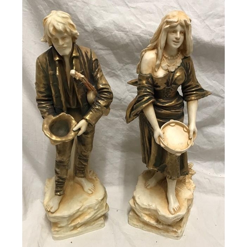 322 - Pair of continental porcelain figurines. Gilt and ivorine effect, street musicians, 34cms h.