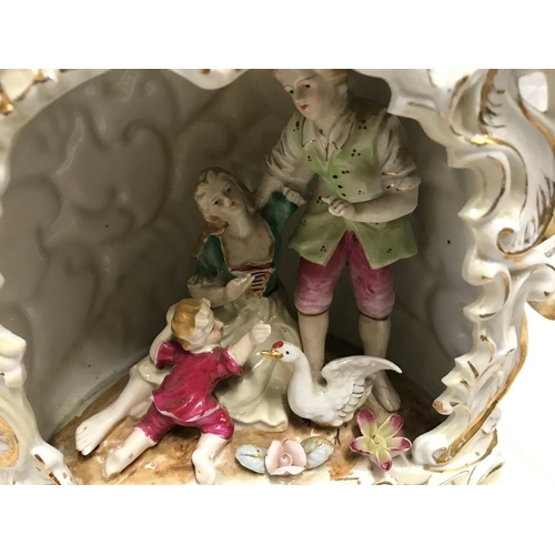 328 - Continental Italian pottery figures. Couple with boy and goose under a archway 22cms h c 23cms w and... 