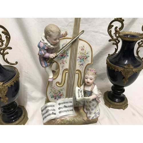 329 - Decorative continental porcelain vase, young boy and girl playing a bass and singing from a song she... 