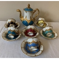 A continental harlequin and gilt porcelain coffee service with blue mark to base, six cups and sauce... 
