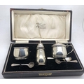 Boxed hallmarked silver cruet set with blue glass liners, Birmingham 1932.