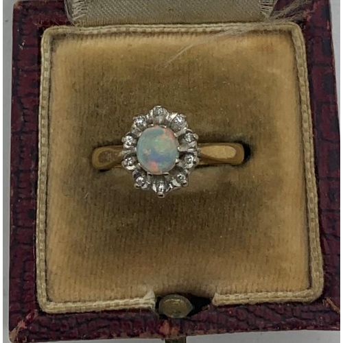 67 - Opal and diamond cluster dress ring set in 18ct gold, size M, 3.6gms total weight.