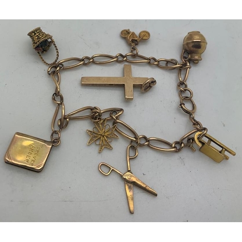 693 - A 9ct charm bracelet and 7 charms and a 9ct gold crucifix. 18gms total weight.