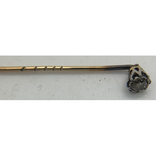 694 - A diamond set tie pin, metal unmarked. 1.3gms total weight.