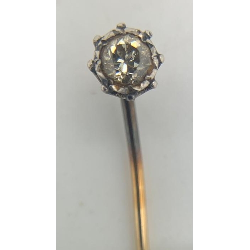 694 - A diamond set tie pin, metal unmarked. 1.3gms total weight.