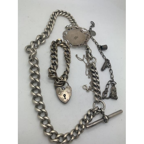 696 - Heavy hallmarked silver watch chain with T bar, hallmarked silver bracelet with padlock, charm brace... 