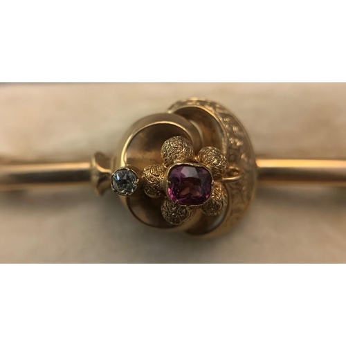 704 - A 9ct gold bar brooch set with central amethyst and one diamond. In original fitted case. 5.4gms tot... 