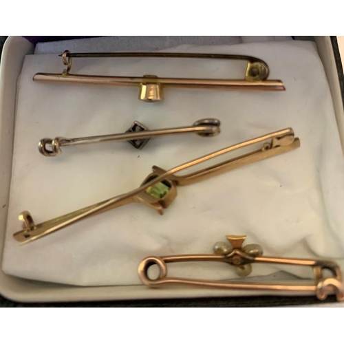 708 - Four early 20thC tie pins to include one set with pale blue stone marked 9ct, one with green stone m... 