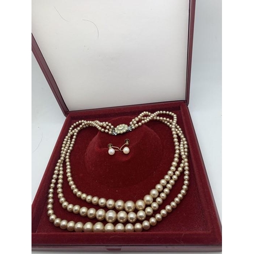 715 - A pair of 9ct gold earrings 1.7gms with a triple strand simulated pearl necklace with diamante clasp... 