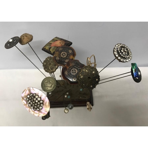 724 - Hat pin cushion stand with a collection of 39 various hat pins including inlaid two silver tortoises... 