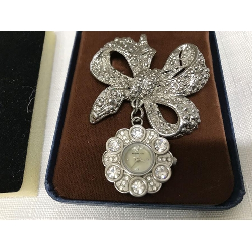 754 - Bespoke pendant brooch watch with bow and a Hollywood pin back brooch, shell form 4.5 x 4cms.