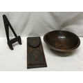 A turned wooden bowl 27 w x 9cms h, an extending carved wooden bookstand 33cms closed and a small wo... 
