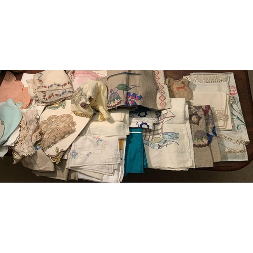 99 - A large quantity of vintage embroidered cloths, chair backs, etc.