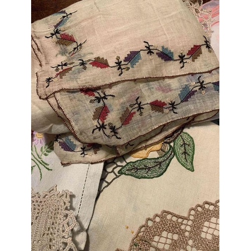 99 - A large quantity of vintage embroidered cloths, chair backs, etc.