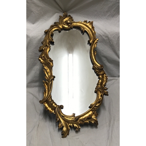 1156 - Decorative gilt framed wall mirror, scroll leaf design. Frame size approx. 82 h x 39cms w.