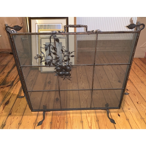 1177 - A metal and mesh fireguard with floral decoration to the front. Closed 70w x 69cms h. Fully opened 1... 