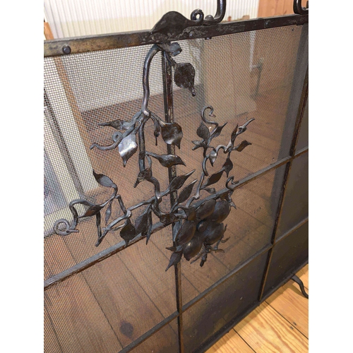 1177 - A metal and mesh fireguard with floral decoration to the front. Closed 70w x 69cms h. Fully opened 1... 