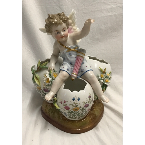 255C - A KPM porcelain figurine cherub sat on three hatched eggs with floral decoration 14cms h x 18cms w.