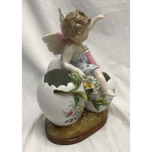 255C - A KPM porcelain figurine cherub sat on three hatched eggs with floral decoration 14cms h x 18cms w.