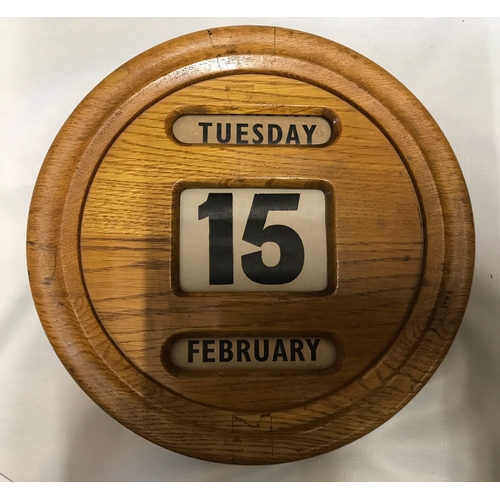 1203 - Two vintage oak framed wall mounted perpetual wall calendars, both with rolling day/date/month.