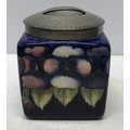 A Tudric pewter mounted dark blue pansy design square biscuit barrel. lid marked H, made in England,... 