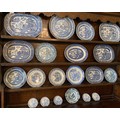 Twenty various blue and white willow patterned plates.