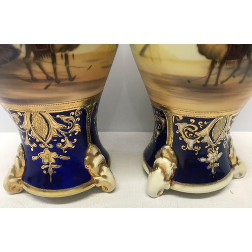 74 - A pair of Japanese Noritake decorative vases 25cm h with blue ground gilded with scenes of Arabian D... 