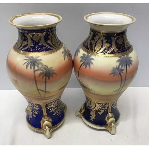 74 - A pair of Japanese Noritake decorative vases 25cm h with blue ground gilded with scenes of Arabian D... 