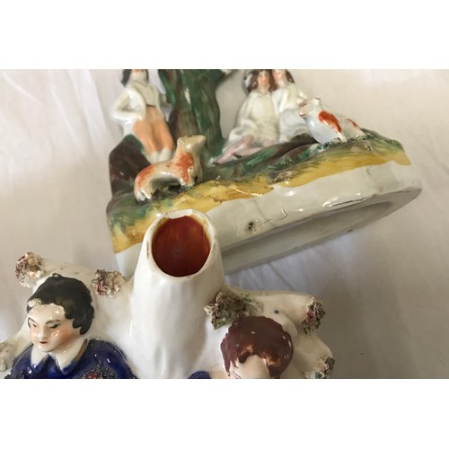 86 - A selection of Staffordshire pottery to include a watch stand 28cms h, a young couple under arch 22c... 