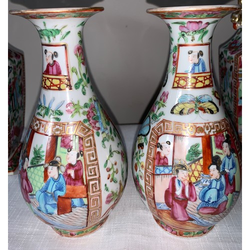 100 - A garniture of four 19thC Chinese famille rose Mandarin pattern tallest 23cms h.